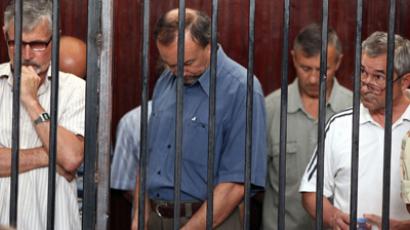 The 24 Eastern European stand behind bars in court during their trial in Tripoli on June 4, 2012 (AFP Photo / Mahmud Turkia) 
