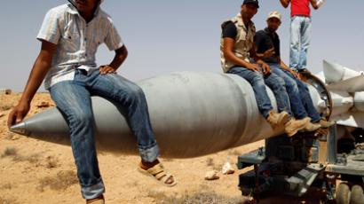 Anti-Gaddafi fighters sit on an SA-5 SAM missile in Burkan air defense military base	(Reuters / Goran Tomasevic)