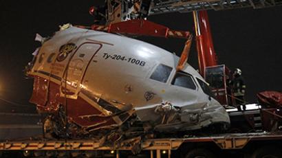 A plane wreckage is removed from a highway near Moscow's Vnukovo airport December 29, 2012. (Reuters/Sergei Karpukhin)