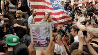 A person with an iPad takes a photograph of a large flag as demonstrators with 'Occupy Wall Street' occupy Zuccotti Park on September 30, 2011 in New York (AFP  Photo / Stan HONDA)