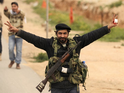 A Libyan rebel fighter flashes the Victory sign in Benghazi on March 19, 2011 (AFP Photo / Patrick Baz)