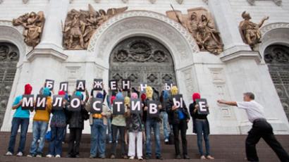 Supporters of female punk group Pussy Riot hold signs to form the message “Blessed are the merciful” during a protest on the steps of the Cathedral of Christ the Saviour in Moscow (REUTERS / Stringer)
