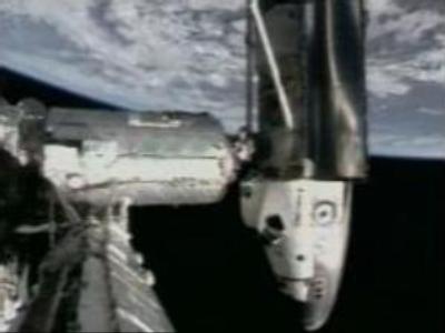 Shuttle spacecraft docks with International Space Station