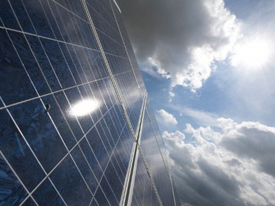 Berlin : The sun is reflected in a solar panel, outside the EQ-SYS factory that makes rotating frames for solar panels, in Feldheim, Brandenburg. (AFP Photo / John Macdougall)