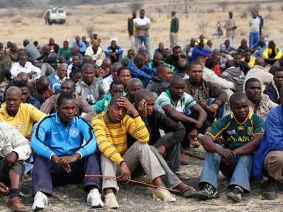 Mine workers gather while on strike near the scene of a shooting at Marikana, in the north western province August 27, 2012 (Reuters / Mike Hutchings)
