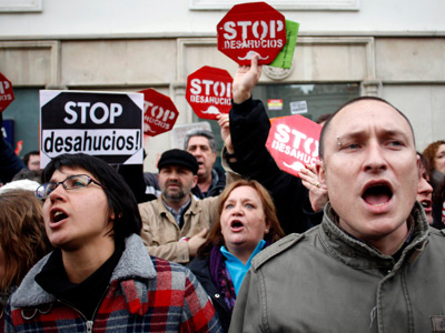 Anti-eviction activists from the Mortgage Victims' Platform (PAH) protest outside parliament during a vote to consider a people's legislative initiative for a new mortgage law, in Madrid, February 12, 2013 (Reuters / Javier Barbancho)