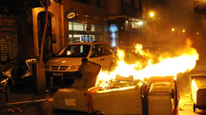 Spain, Madrid: Waste containers burn after a demonstration against the Spanish government's latest austerity measures in downtown Madrid on July 19, 2012 (AFP Photo / Dominique Faget)