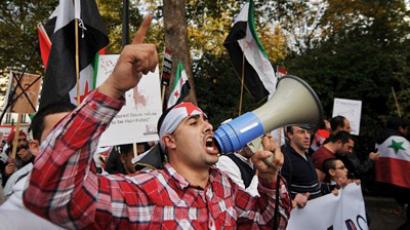 A protestor uses a megaphone during a demonstration against the regime of Syrian president Bashar al-Assad (AFP Photo / BEN STANSALL)