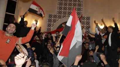 Syrians protest outside the Qatari Embassy in Damascus on November 12, 2011, hours after a statement, read by Qatari Prime Minister Hamad bin Jassem Al-Thani, said the Arab League had decided "to suspend Syrian delegations' activities in Arab League meetings" and to implement "economic and political sanctions" against Damascus (AFP Photo / LOUAI BESHARA)