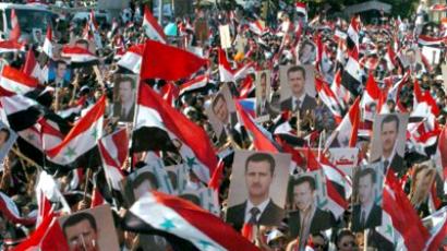 Syria, Latakia: A handout picture released by the Syrian Arab News Agency on October 27, 2011, shows Syrians waving the national flag as they rally during a mass demonstration in support of President Bashar al-Assad, in the city of Latakia of north of Damascus. (AFP Photo / Ho-Sana)