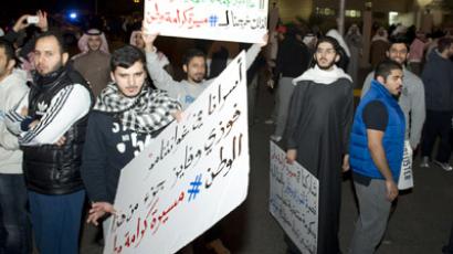 Demonstrators carry placards during a protest in Kuwait City January 6, 2013. (Reuters/Stephanie Mcgehee)