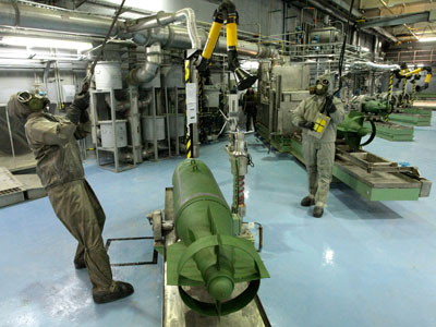Workers dressed in protective gear prepare a chemical bomb for destruction at a special facility in Russia's Urals town of Shchuchye.(REUTERS / Handout)