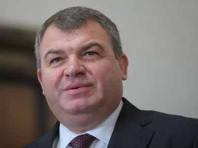 Former defense minister’s home searched, aide charged