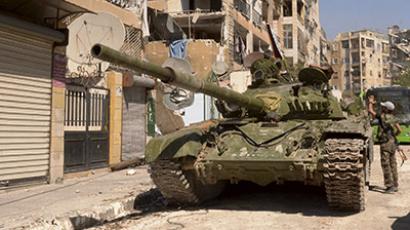 A Syrian army tank is seen next to damaged buildings after clashes between Free Syrian Army fighters and regime forces in the Seif El Dawla neighbourhood of Aleppo city, northwest of Syria September 13, 2012. (Reuters/George Ourfalian)