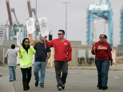 Picketing port employees enter 6th day of talks amid $1 billion per day strike