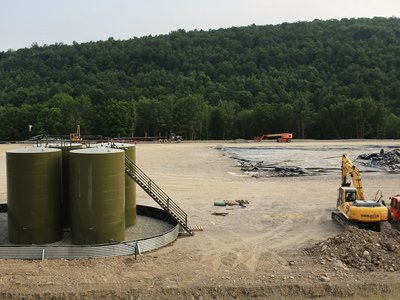 Earth moving equipment and natural gas containers are viewed at a hydraulic fracturing site on June 19, 2012 in South Montrose, Pennsylvania (AFP Photo / Spencer Platt)