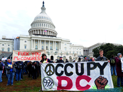 Occupy DC protesters holds a signs January 17, 2012 during a demonstration in front of the Capitol in Washington, DC. (AFP Photo / Karen Bleier)