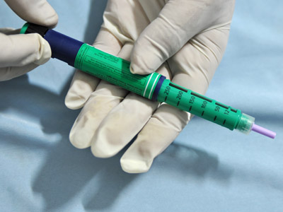 A medical assistant holds an insulin pen administered to diabetes patients (AFP Photo)