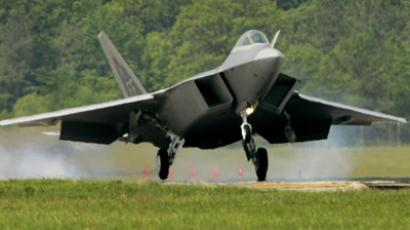 The first F/A-22 Raptor destined for the First Fighter Wing touches down shortly before being delivered.(AFP Photo / Win McNamee)