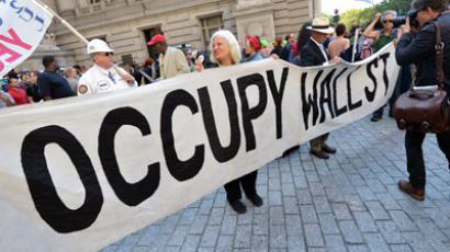 People hold a banner at the Occupy Wall Street protest September 17, 2012 on the one year anniversary of the movement in New York. (AFP Photo/Stan Honda)
