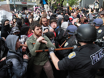 Occupy Seattle protesters are pushed back by police officers during a march and demonstration on May Day in downtown Seattle, Washington May 1, 2012 (Reuters/Robert Sorbo)
