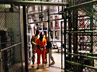 Cuba, Guantanamo Bay: A "non-compliant" detainee is escorted by guards after showering inside the U.S. military prison for "enemy combatants" on October 27, 2009 in Guantanamo Bay, Cuba. (AFP Photo / John Moore)