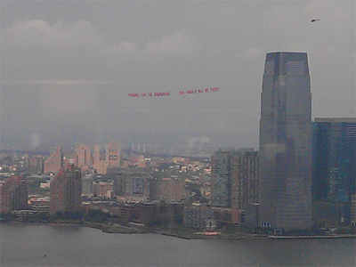 Ad over Wall Street says "You Should All Be Fired"