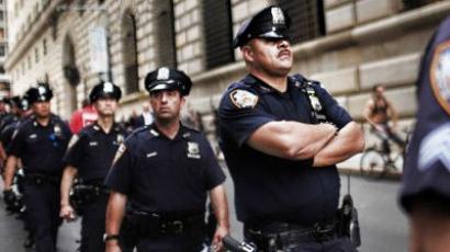 Police stand guard against demonstrators opposed to corporate profits on Wall Street during a march in the Financial District on September 26, 2011 New York City. (Spencer Platt/Getty Images/AFP )