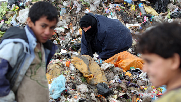 An Iraqi woman searches for plastic bottles in a garbage dump on the outskirts of Baghdad's impoverished district of Sadr City, January 30, 2013 (AFP Photo/ Ahmad Al-Rubaye)