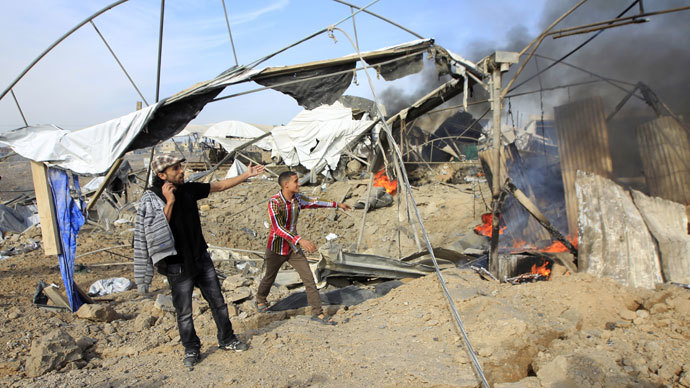 Palestinian men react after an Israeli air strike on smuggling tunnels between the southern Gaza Strip.(AFP Photo / Said Khatib)