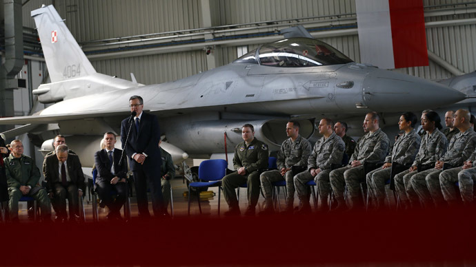 U.S. and Polish soldiers listen as Poland's President Bronislaw Komorowski speaks during his visit at the Lask airbase in central Poland March 11, 2014. (Reuters/Kacper Pempel)