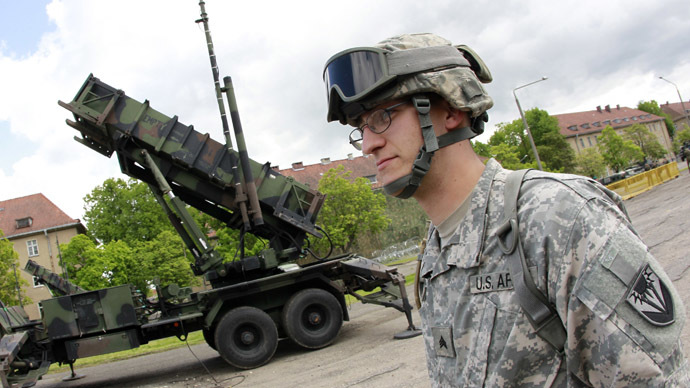 A U.S. soldier stands next to a Patriot surface-to-air missile battery at an army base in Morag, Poland May 26, 2010. (Reuters/Peter Andrews)