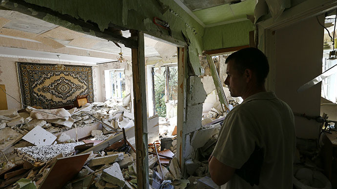 A local resident stands inside an apartment inside a block of flats damaged by a recent shelling in the eastern Ukrainian town of Kramatorsk July 1, 2014. (Reuters / Shamil Zhumatov)