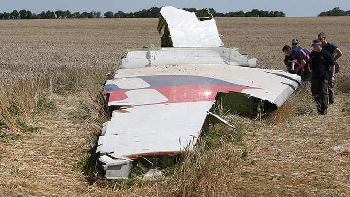 Members of a group of international experts inspect wreckage at the site where the downed Malaysia Airlines flight MH17 crashed, near the village of Hrabove (Grabovo) in Donetsk region, eastern Ukraine (Reuters / Sergey Karpukhin)