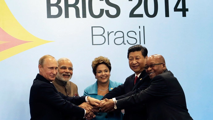 (L-R) Russian President Vladimir Putin, Indian Prime Minister Narendra Modi, Brazilian President Dilma Rousseff, Chinese President Xi Jinping and South African President Jacob Zuma join their hands at a group photo session during the 6th BRICS summit in Fortaleza July 15, 2014.(Reuters / Nacho Doce )
