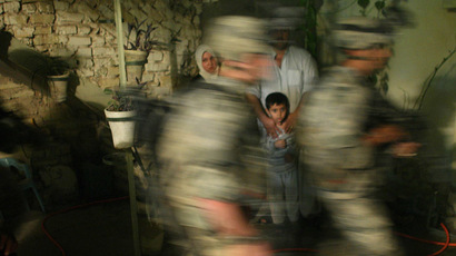 An Iraqi family watches U.S. soldiers in in Baquba early June 28, 2007.  (Reuters/Goran Tomasevic)