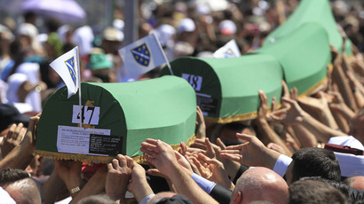 People carry coffins to graves at the Memorial Center Potocari, near Srebrenica, Bosnia and Herzegovina July 11, 2015. (Reuters/Antonio Bronic)